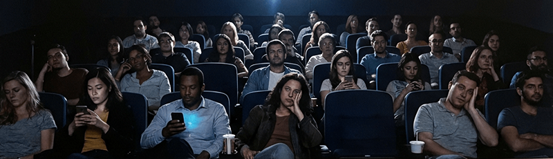 Audience members getting bored in a movie theater